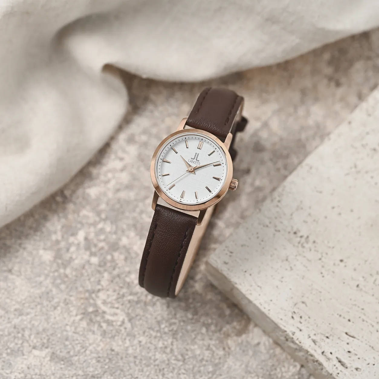 LANCETTI watches arranged in soft window light.